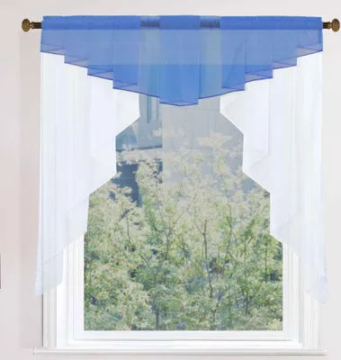 A window with blue and white sheer curtains hanging.