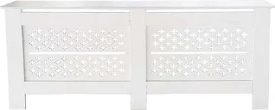 A white radiator cover with a decorative pattern.