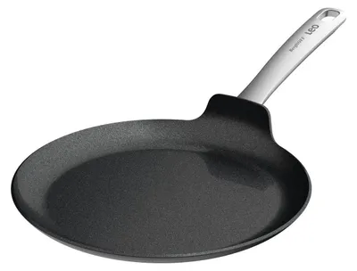 A black pancake pan with a silver handle is shown against a white background.