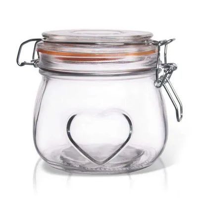 A clear studio shot of a glass jar with a heart design on a white background.