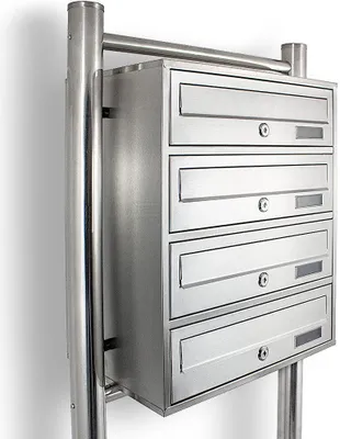 A multi-unit stainless steel mailbox system mounted on a pole.