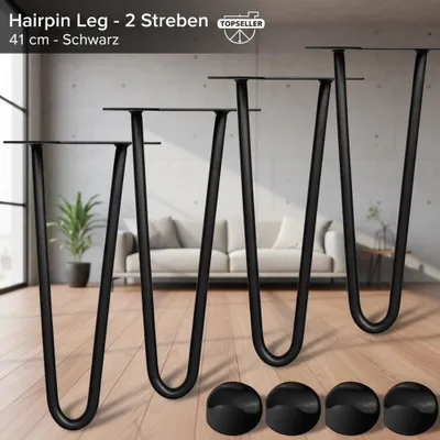 Four black hairpin legs are displayed in a room setting with a sofa in the background. There are also four black circular floor protectors shown in the foreground.
