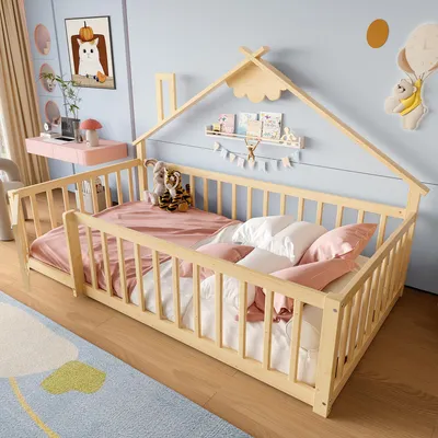 A child's bedroom with a wooden bed, desk, and rug.