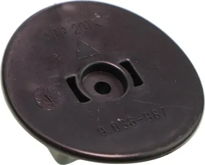 A close-up view of a black plastic component with embossed text and symbols.