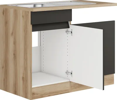 A kitchen sink cabinet with the doors open, showing the interior and the countertop with a sink.