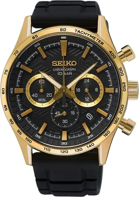 A close-up, front-facing studio shot of a gold and black Seiko chronograph watch with a black rubber strap.