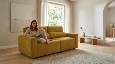 Produktbild von Schlafsofa KOMO Apollo – mit Schlaffunktion, Cord in Senfgelb, Family Meble, KI-generiertes Bild