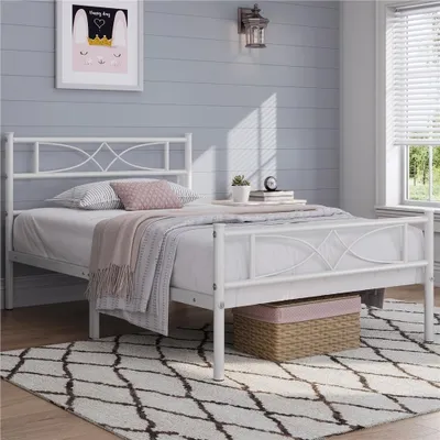 A white metal bed frame with a mattress and bedding is shown in a bedroom setting.