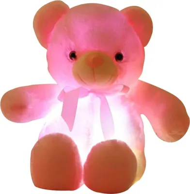A pink teddy bear illuminated from within, sitting against a white background.
