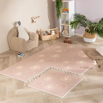 A child's play area with a soft rug, armchair, and shelving unit.