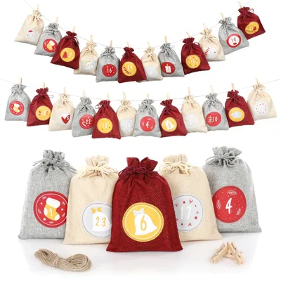 A collection of small fabric bags arranged in rows, some hanging on a string, and others standing upright.