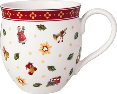 A white mug with a festive Christmas pattern, including Santa Claus, a train, a stocking, holly, and other holiday motifs. The mug has a red and gold decorative band around the rim and a white handle.