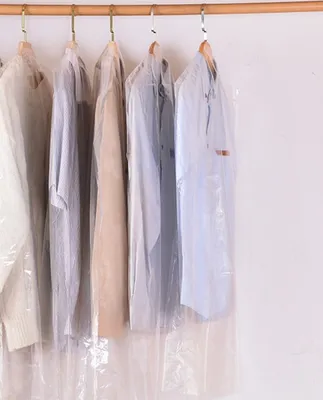 Garment bags hanging on a rack.