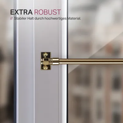 Close-up of a gold-colored cafe curtain rod attached to a white window frame.