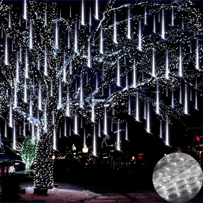 A tree decorated with white LED meteor shower lights at night.