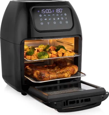 A black air fryer oven with food inside, viewed from the front with the door open.