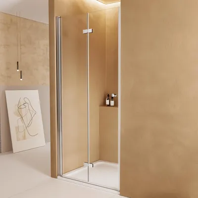 A modern bathroom with a glass shower enclosure.
