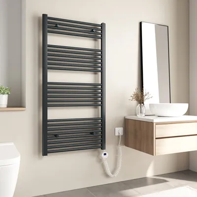 A modern bathroom with a dark gray electric towel warmer mounted on the wall.