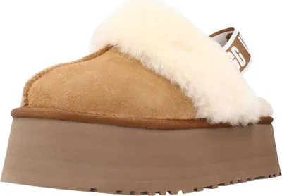 A side view of a tan UGG slipper with a cream-colored fuzzy lining and a thick platform sole.
