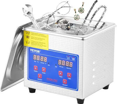 A stainless steel ultrasonic cleaner with a digital display and controls, filled with water and containing various items for cleaning.