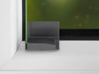 A close-up view of a window fitting with a green cord.