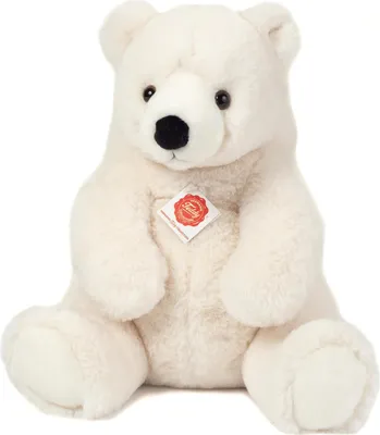 A white teddy bear sitting down, facing the camera.