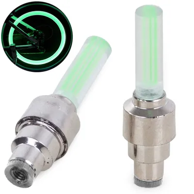 Two green LED valve caps for bicycle tires are shown against a white background. A smaller inset image shows one of the valve caps illuminating a bicycle wheel.