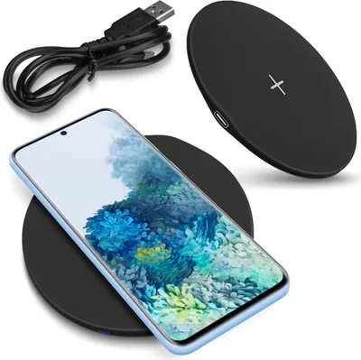 A smartphone is placed on a wireless charging pad, with a USB cable nearby.