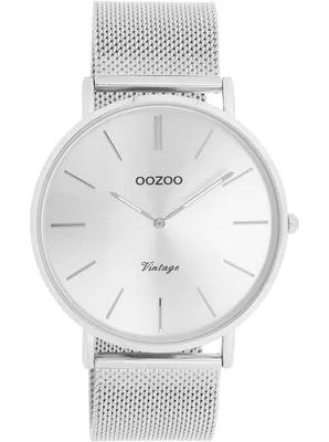 A close-up, front-facing studio shot of a silver wristwatch with a mesh band.