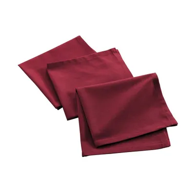 Three folded burgundy fabric napkins are arranged diagonally on a white background.