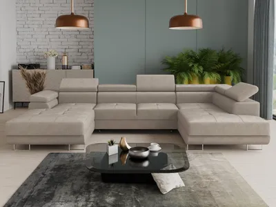 A modern living room with a large U-shaped sectional sofa, coffee table, and plants.