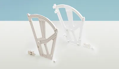 Two white plastic shoe cabinet fittings are displayed on a white surface with a light blue background.