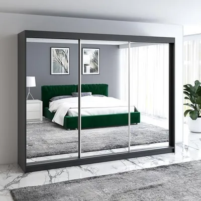 A bedroom scene reflected in a wardrobe with mirrored doors.