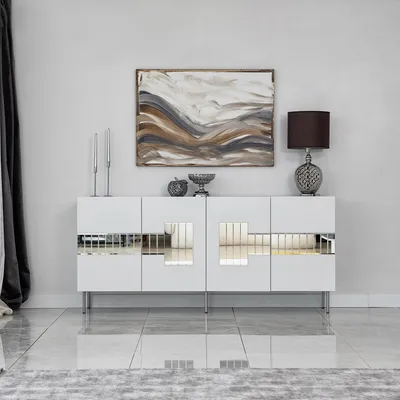 A modern white sideboard with mirrored accents is displayed in a minimalist room.