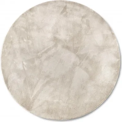 A round, cream-colored rug with a high pile and a textured, slightly uneven surface.