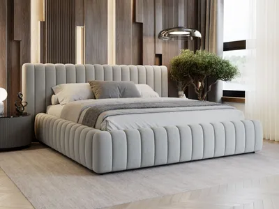 A modern bedroom with a large upholstered bed, decorative wooden wall paneling, and a small tree.