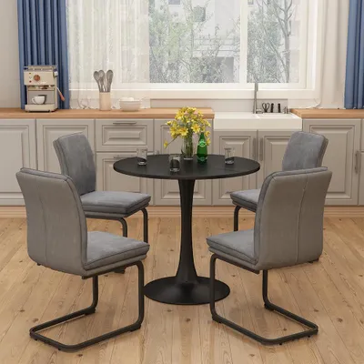 A dining set with a round table and four chairs in a kitchen setting.