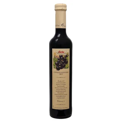 A bottle of blackcurrant syrup on a white background.