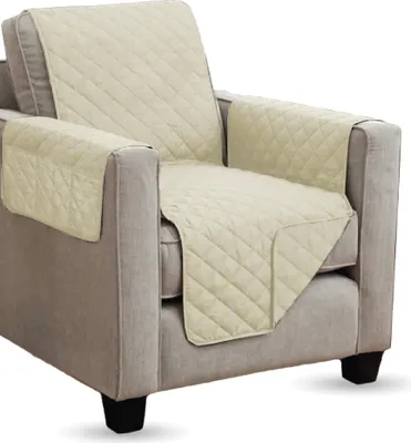 A quilted slipcover on an armchair.