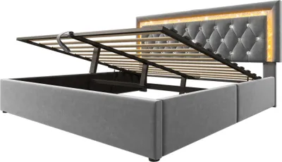 A bed frame with its storage lift mechanism open, showing the internal storage space and the slatted base.