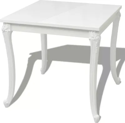 A white square dining table with ornate legs.