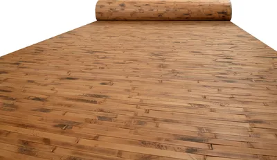 A roll of wood-like laminate material, unrolled to show its texture and pattern.