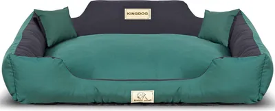 A dog bed with two small pillows on a white background.
