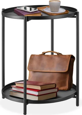 A two-tiered round side table with items on each tier.