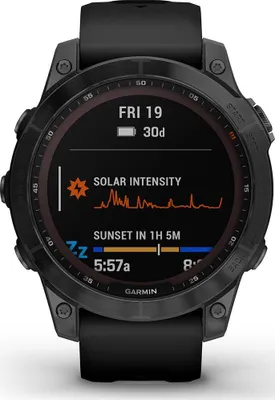 A close-up view of a Garmin Fenix 7 Sapphire Solar smartwatch with a black silicone band, displaying various information on its screen.