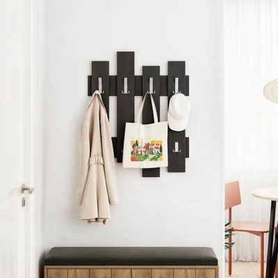 An entryway with a coat rack, a bench, and a door.
