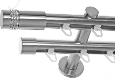 Close-up view of two curtain rods mounted on a wall.