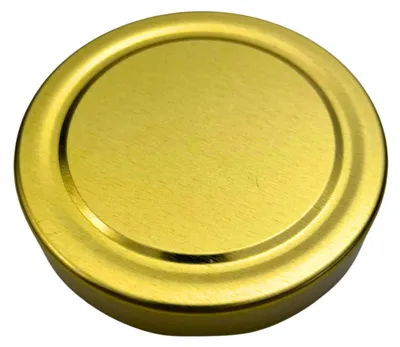 A close-up, top-down view of a single gold-colored jar lid.