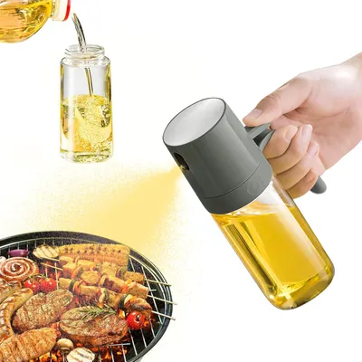 A hand is holding an oil sprayer over a grill with food on it. Another oil bottle is being poured into a small container.