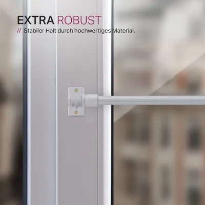 Close-up of a white curtain rod attached to a window frame with a bracket.